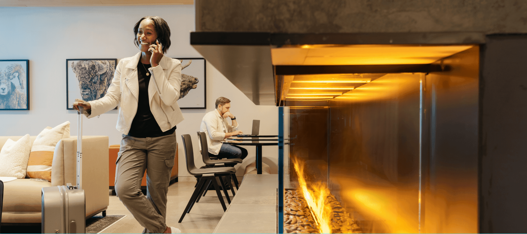 Travelers walking through a modern airport terminal with bright illuminated corridor in the background