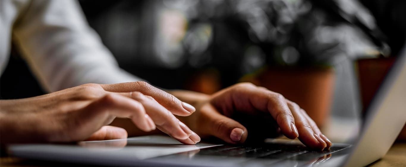 Person typing on a laptop keyboard