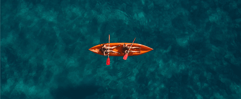 Summer travelers kayaking in blue waters